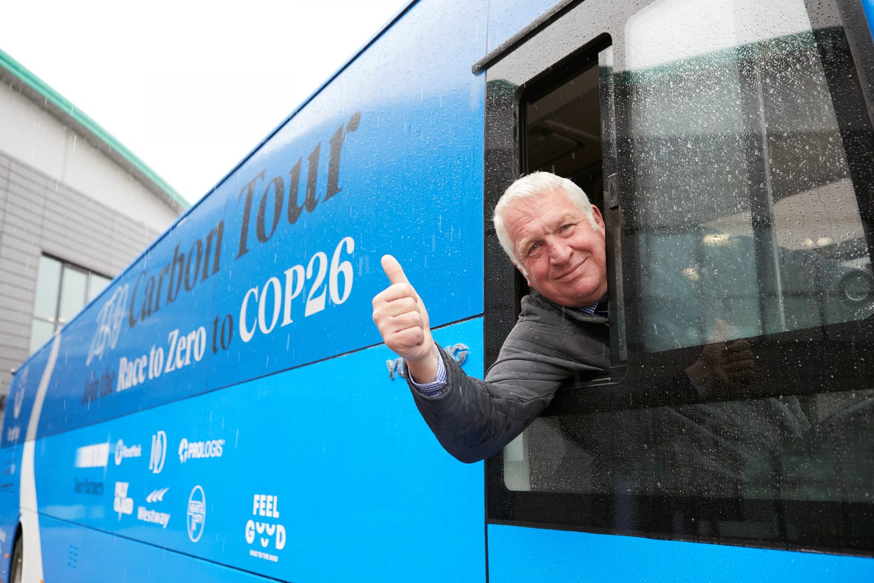 Image showing Sir Mike Penning MP giving the thumbs up whilst sat on the Zero Carbon Tour coach